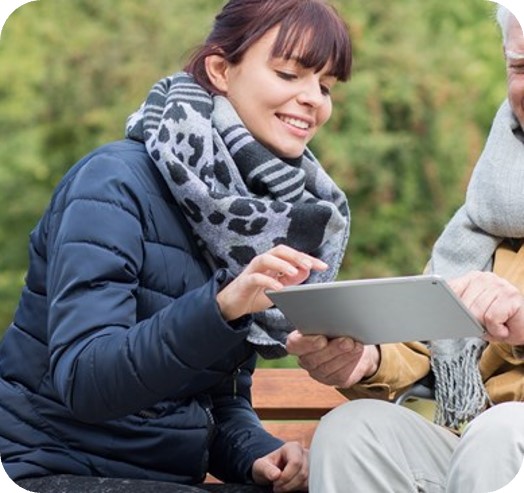 two persons using a tablet